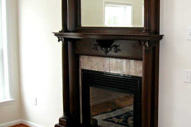 Traditional living room in Philadelphia with a standard fireplace, a wood fireplace surround and no tv.