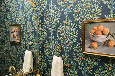 Example of a small transitional wallpaper powder room design in Orlando with green cabinets, multicolored walls, an undermount sink, quartz countertops, beige countertops and a built-in vanity