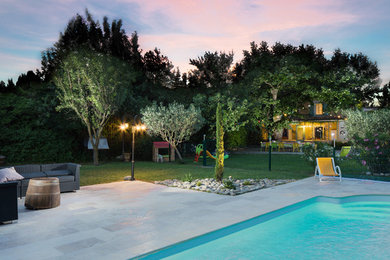 Photo of a modern rectangular pool in Marseille with natural stone pavers.