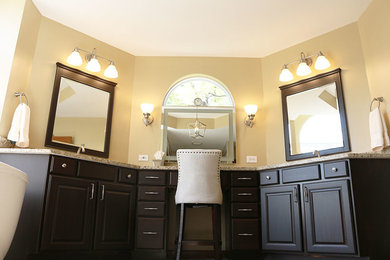 Large master beige tile and ceramic tile ceramic tile and multicolored floor bathroom photo in St Louis with raised-panel cabinets, brown cabinets, a two-piece toilet, beige walls, an undermount sink, granite countertops, a hinged shower door and beige countertops