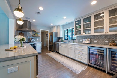 Inspiration for a transitional kitchen in Other with a single-bowl sink, shaker cabinets, quartzite benchtops, grey splashback, subway tile splashback, stainless steel appliances, light hardwood floors and a peninsula.