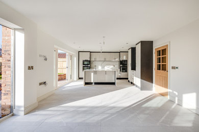 Medium sized contemporary kitchen in Cheshire with an island.