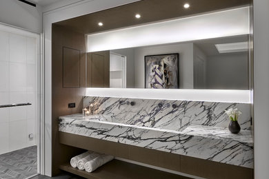 Design ideas for a large modern master bathroom in Chicago with flat-panel cabinets, brown walls, slate floors, a trough sink, marble benchtops and black floor.