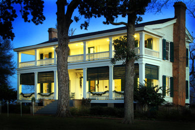 Inspiration for a large timeless white two-story wood exterior home remodel in New Orleans with a shingle roof