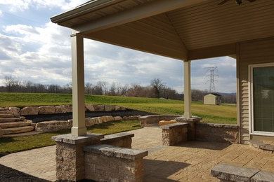 Large mountain style backyard tile patio photo in Philadelphia with a fire pit and a roof extension