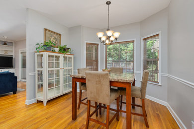 Enclosed dining room - mid-sized traditional medium tone wood floor enclosed dining room idea in Nashville with gray walls