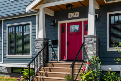 Example of a large transitional blue two-story concrete fiberboard house exterior design in Vancouver