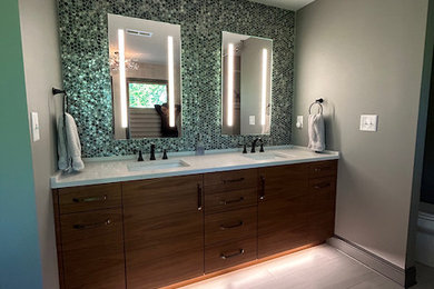 Inspiration for a large modern master porcelain tile porcelain tile and double-sink bathroom remodel in Atlanta with flat-panel cabinets, brown cabinets, a two-piece toilet, gray walls, an undermount sink, quartz countertops, white countertops and a built-in vanity