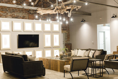 Imagen de sala de juegos en casa abierta urbana grande con paredes grises, suelo de cemento, televisor colgado en la pared y suelo gris