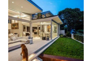 Photo of a large contemporary backyard patio in Sydney with concrete pavers and no cover.
