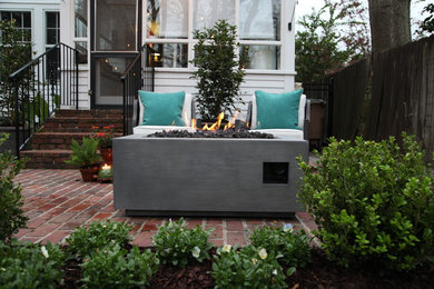 Patio - small traditional courtyard brick patio idea in Miami with a fire pit and no cover