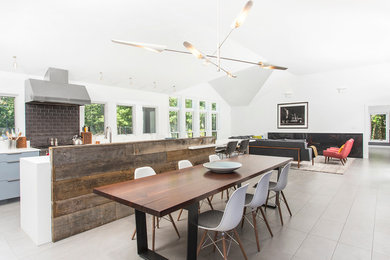 Inspiration for a large contemporary porcelain tile great room remodel in New York with white walls and no fireplace
