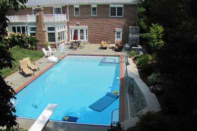 Inspiration for a large timeless backyard stone and rectangular hot tub remodel in DC Metro