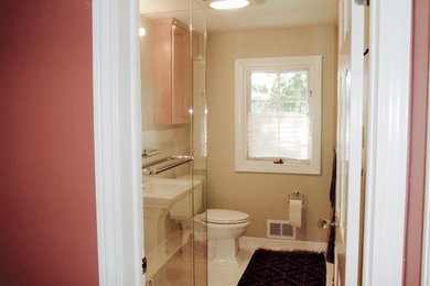 Inspiration for a mid-sized modern master white tile and ceramic tile ceramic tile corner shower remodel in Detroit with light wood cabinets, a one-piece toilet, beige walls and a pedestal sink