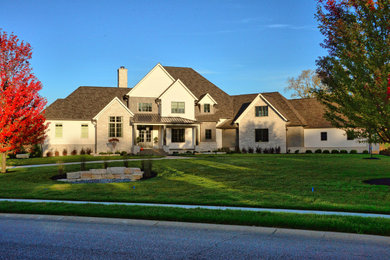 Large country multicolored three-story mixed siding exterior home idea in Indianapolis with a mixed material roof