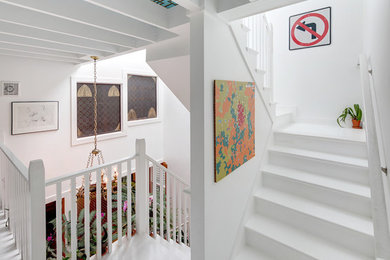 Inspiration for a small eclectic painted l-shaped staircase remodel in Boston with painted risers