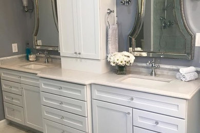 Inspiration for a mid-sized transitional 3/4 beige tile, white tile and stone slab porcelain tile bathroom remodel in Orange County with raised-panel cabinets, white cabinets, a one-piece toilet, gray walls, a drop-in sink and soapstone countertops