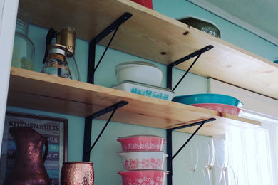 Inspiration for a mid-sized shabby-chic style u-shaped multicolored floor enclosed kitchen remodel in Grand Rapids with an undermount sink, shaker cabinets, gray cabinets, granite countertops, gray backsplash, glass tile backsplash, stainless steel appliances, no island and gray countertops
