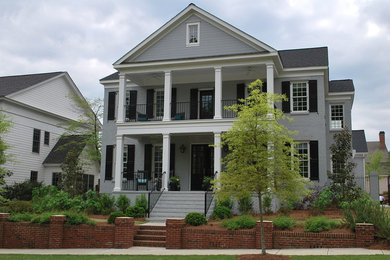 Inspiration for a mid-sized timeless gray two-story brick exterior home remodel in Birmingham with a shingle roof