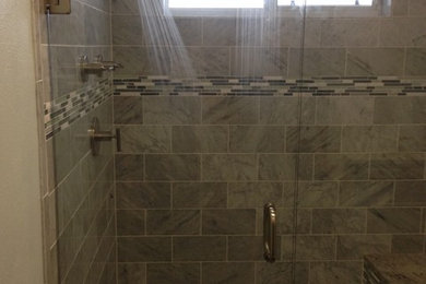 Alcove shower - mid-sized contemporary master gray tile alcove shower idea in Dallas with shaker cabinets, white cabinets, a two-piece toilet, beige walls, granite countertops and an undermount sink