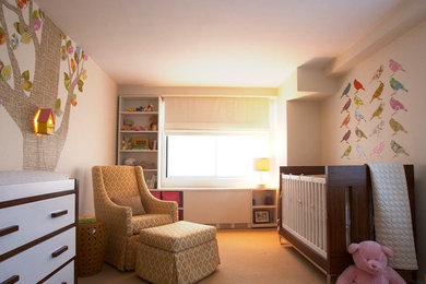 Mid-sized contemporary gender-neutral nursery in New York with white walls, carpet and beige floor.