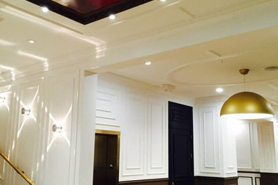 Large transitional hallway photo in Houston with white walls