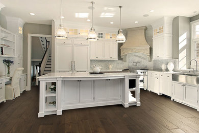 Inspiration for a large traditional u-shaped eat-in kitchen in Other with a farmhouse sink, shaker cabinets, white cabinets, marble benchtops, white splashback, stone slab splashback, stainless steel appliances, dark hardwood floors and with island.