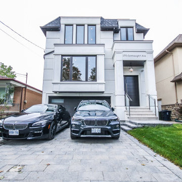 Landscaped Front Yard with Paved Driveway and Modern Entryway