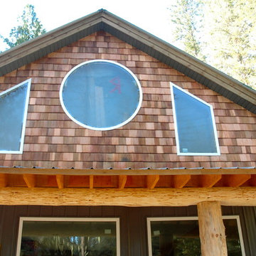 Cedar shake gable and log covered deck on garage