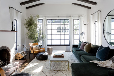 Inspiration for a transitional dark wood floor and brown floor living room remodel in Los Angeles with white walls, a standard fireplace and no tv
