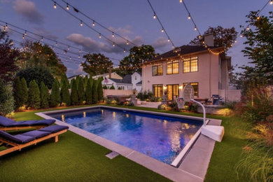 Inspiration for a large modern backyard concrete paver patio kitchen remodel in New York with no cover