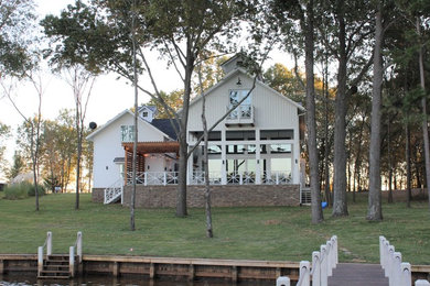 Large cottage white three-story mixed siding exterior home photo in Other with a mixed material roof