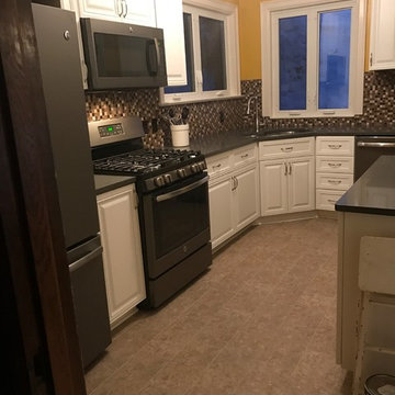 cabinet refacing--white cabinets with quartz countertop backsplash and floor