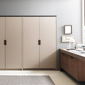 Lacquer pantry doors with recessed metal handles.