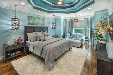 Inspiration for a large contemporary master medium tone wood floor, brown floor and tray ceiling bedroom remodel in Atlanta with blue walls