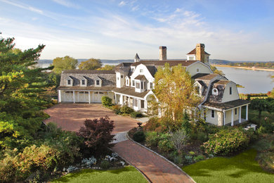 Inspiration for a huge timeless white three-story concrete fiberboard house exterior remodel in New York with a shingle roof