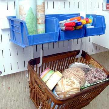 Wall Control craft pegboard being used with peg U-Hooks to hold a basket beneath