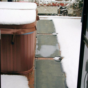 Paul walks to his hot tub with bare feet after the snow