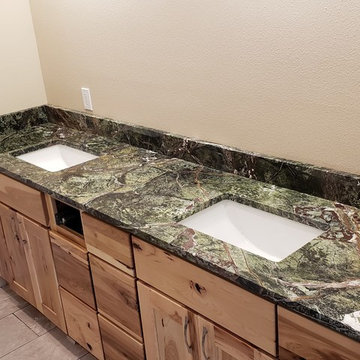 Two Green Rainforest Marble Bathrooms