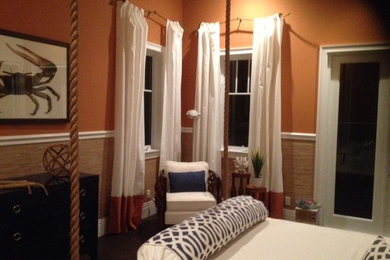 Bedroom - mid-sized coastal guest medium tone wood floor bedroom idea in Miami with orange walls