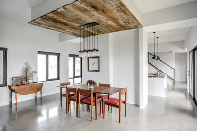 Inspiration for a large contemporary concrete floor and gray floor great room remodel in Toronto with white walls and no fireplace