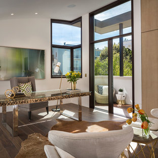 Example of a trendy freestanding desk dark wood floor and brown floor study room design in San Francisco with white walls and no fireplace