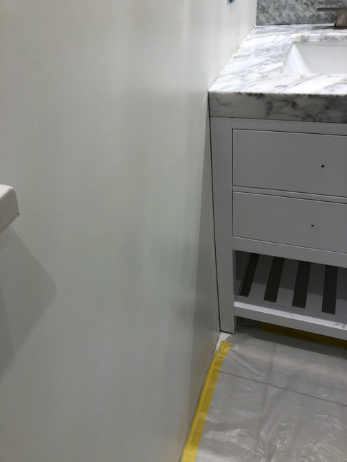 how to fill a gap between vanity and side wall, baseboard issue too