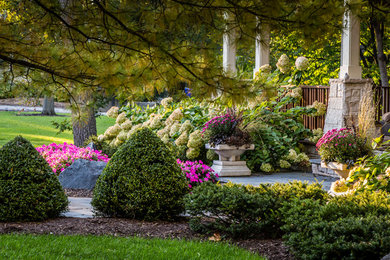 This is an example of a large craftsman partial sun front yard concrete paver walkway in Chicago.