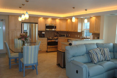 Inspiration for a small coastal l-shaped porcelain tile open concept kitchen remodel in Tampa with an undermount sink, recessed-panel cabinets, light wood cabinets, granite countertops, multicolored backsplash, mosaic tile backsplash, stainless steel appliances and a peninsula