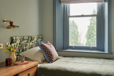 Photo of a contemporary bedroom in Other with green walls, dark hardwood flooring and brown floors.