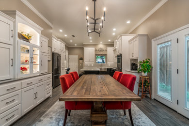 Trendy u-shaped ceramic tile and gray floor eat-in kitchen photo in Other with a farmhouse sink, recessed-panel cabinets, quartz countertops, gray backsplash, ceramic backsplash, black appliances, an island and white countertops