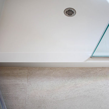 White Master Bathroom with Freestand Tub and Corian Solid Surface Shower