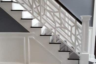 Inspiration for a mid-sized transitional wooden l-shaped wood railing staircase remodel in New York with painted risers