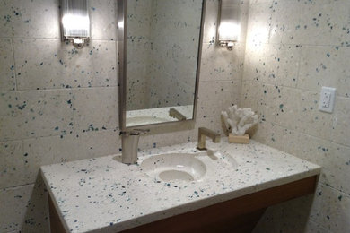Inspiration for a mid-sized tropical 3/4 beige tile and stone tile concrete floor bathroom remodel in Miami with open cabinets, medium tone wood cabinets, an integrated sink, beige walls and concrete countertops